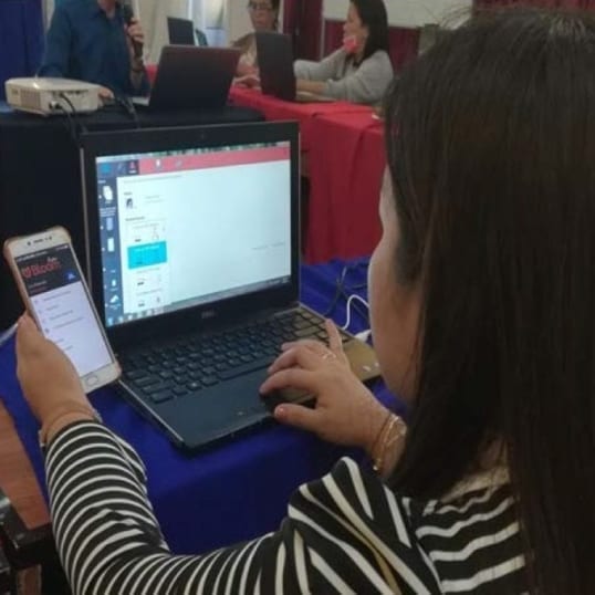 A woman tests accessibility features added to Bloom software.
