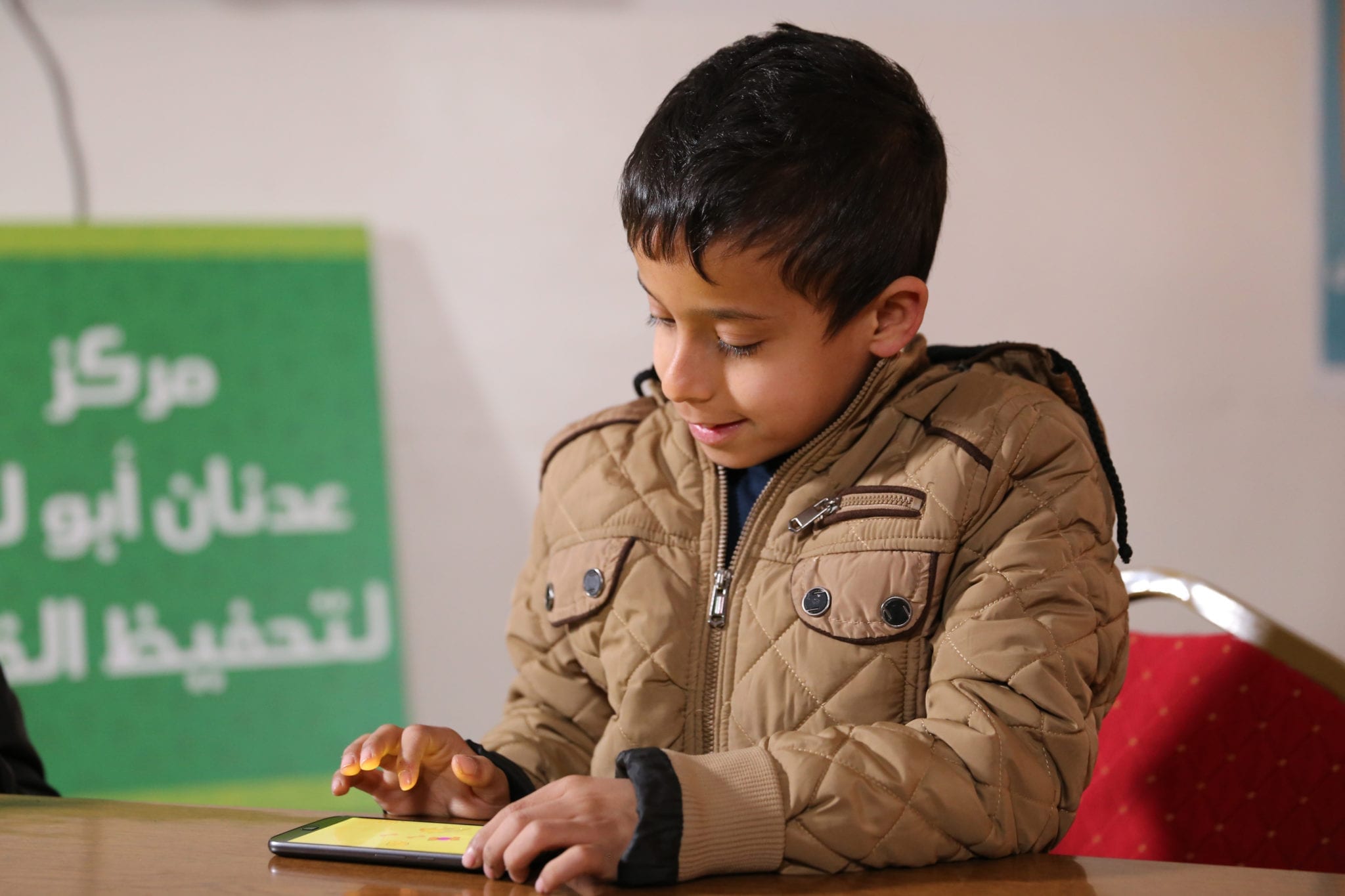 Syrian refugee child plays Antura and the Letters literacy learning app funded by the EduApp4Syria competition.