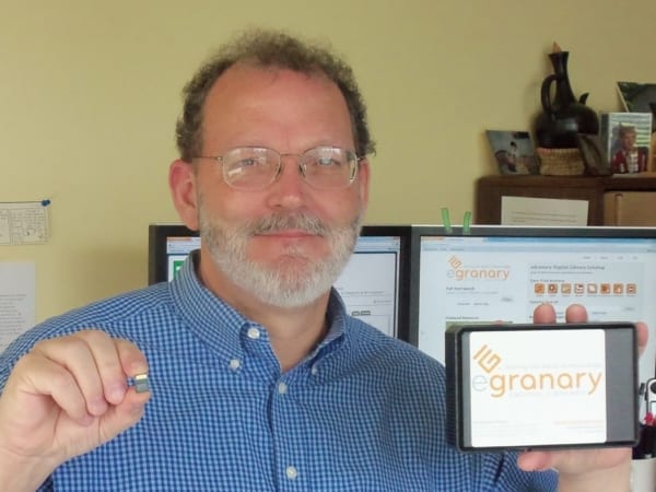 Man holding smartphone featuring egranary digital pocket library.