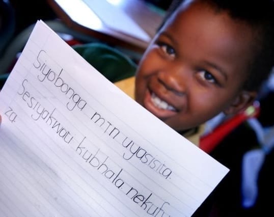 A child in South Africa reads and writes through the Molteno Institute for Language and Literacy.