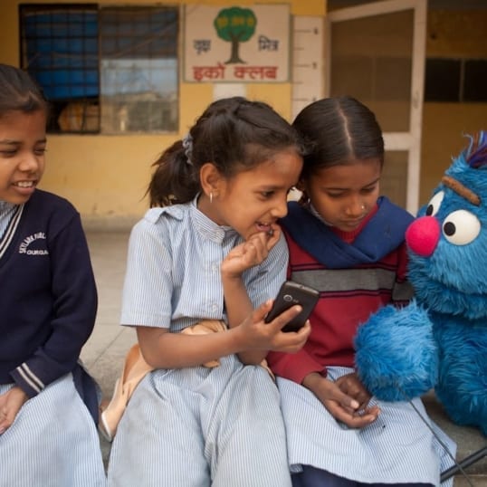 Children in India enjoy a smartphone app with self-paced audio storybooks in the Marathi language created by ACR Round 2 grantee, Sesame Workshop India Trust. Photo credit: Sesame Workshop India Trust.