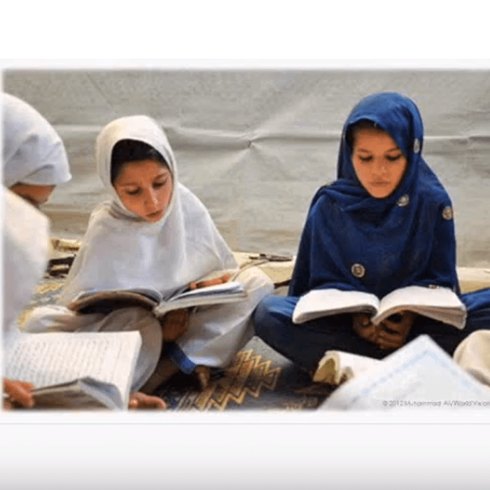 All Children Reading, USAID, World Vision and Australian Aid logo next to two young girls reading books.