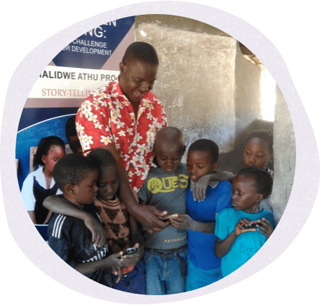 a standing group of children playing on cell phones