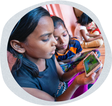 two young girls watching tv on a cell phone