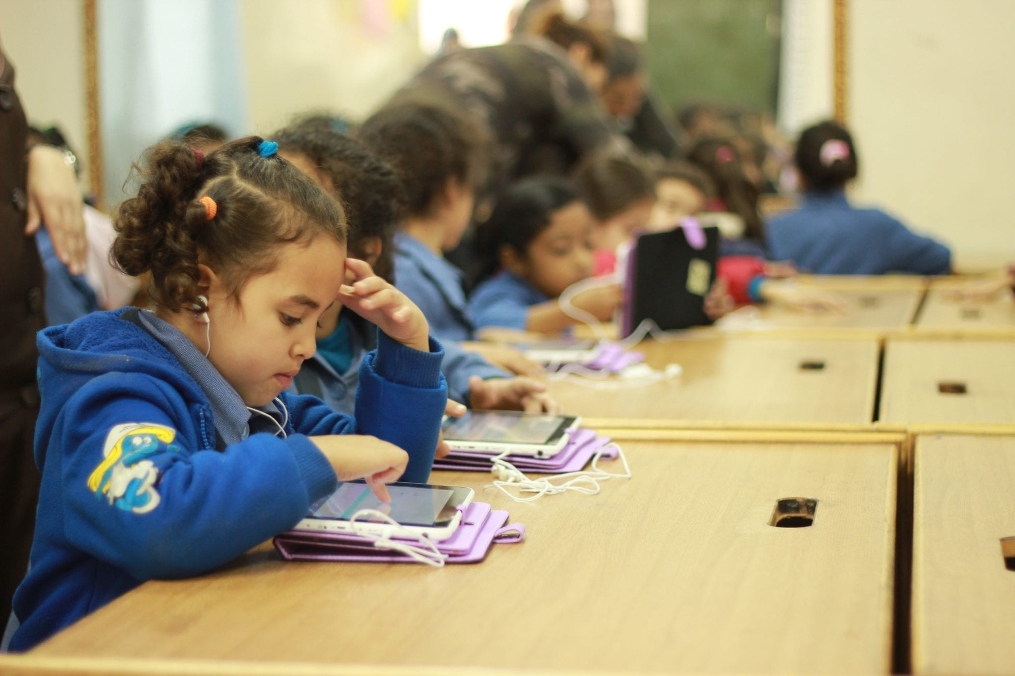 Children in Jordan read digital books by Little Thinking Minds created through ACR GCD's 2014 Grant Competition.