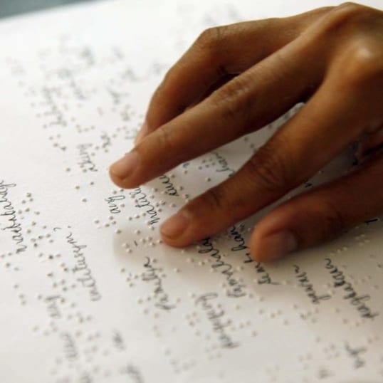 A student in India reads braille.