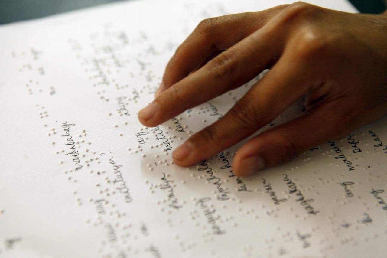 A student in India reads braille.