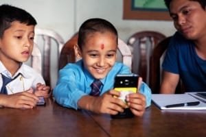 A child reads a book from The Asia Foundation's Let's Read Digital Library.
