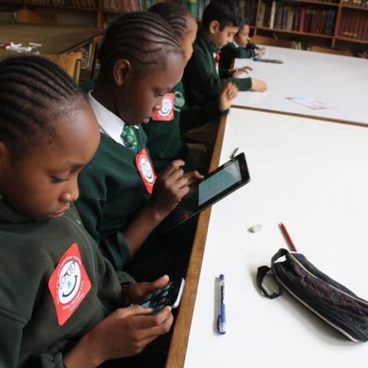 Children in Kenya interact with accessible digital books created by eKitabu.