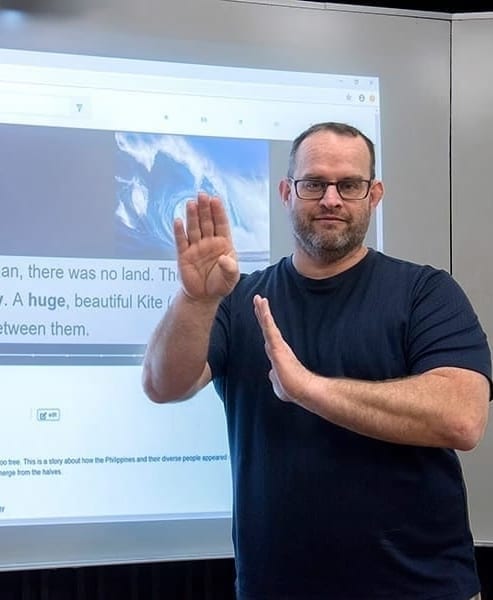 Christopher Kurz of RIT/NTID signs an introduction to the World Around You digital library.