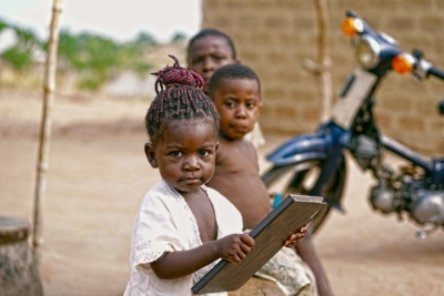 A young girl holding a tablet.