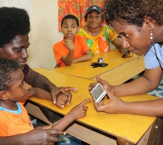 A child in Papua New Guinea learns using a smartphone app.
