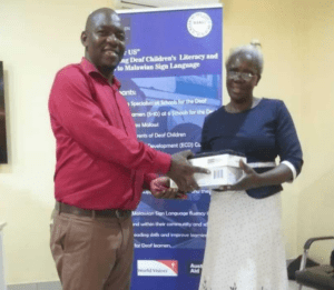 MANAD’s Mr Sekerani Kufakwina, Promoting MSL Accessible Books Coordinator handing over the Devices to Ms Grace Nyirenda the Headteacher for Karonga School for the Deaf